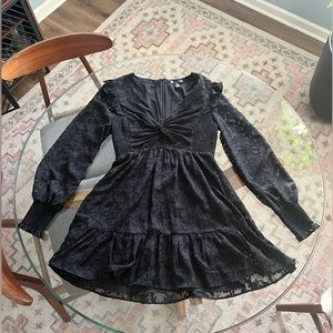 Black mini dress with lace overlay and sheer lace long sleeves by Aqua